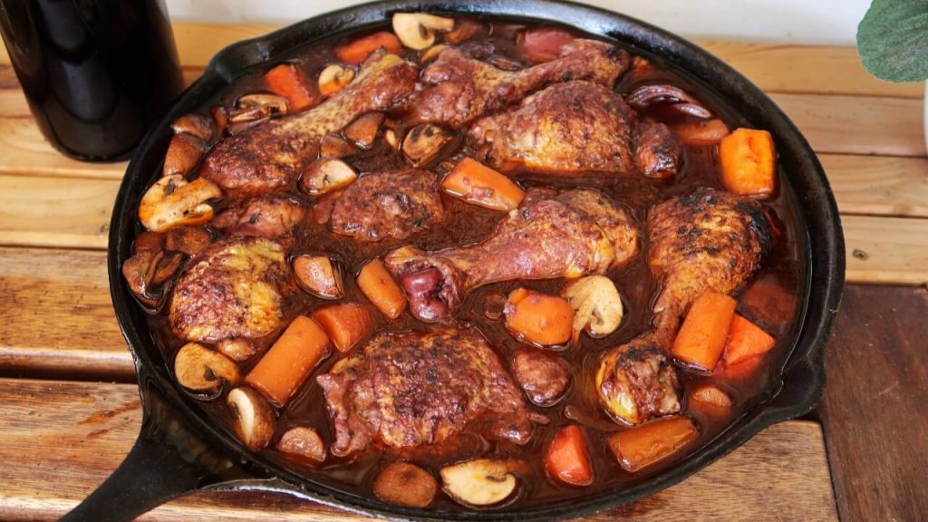 Aserving dish of a warm and conforting coq au vin